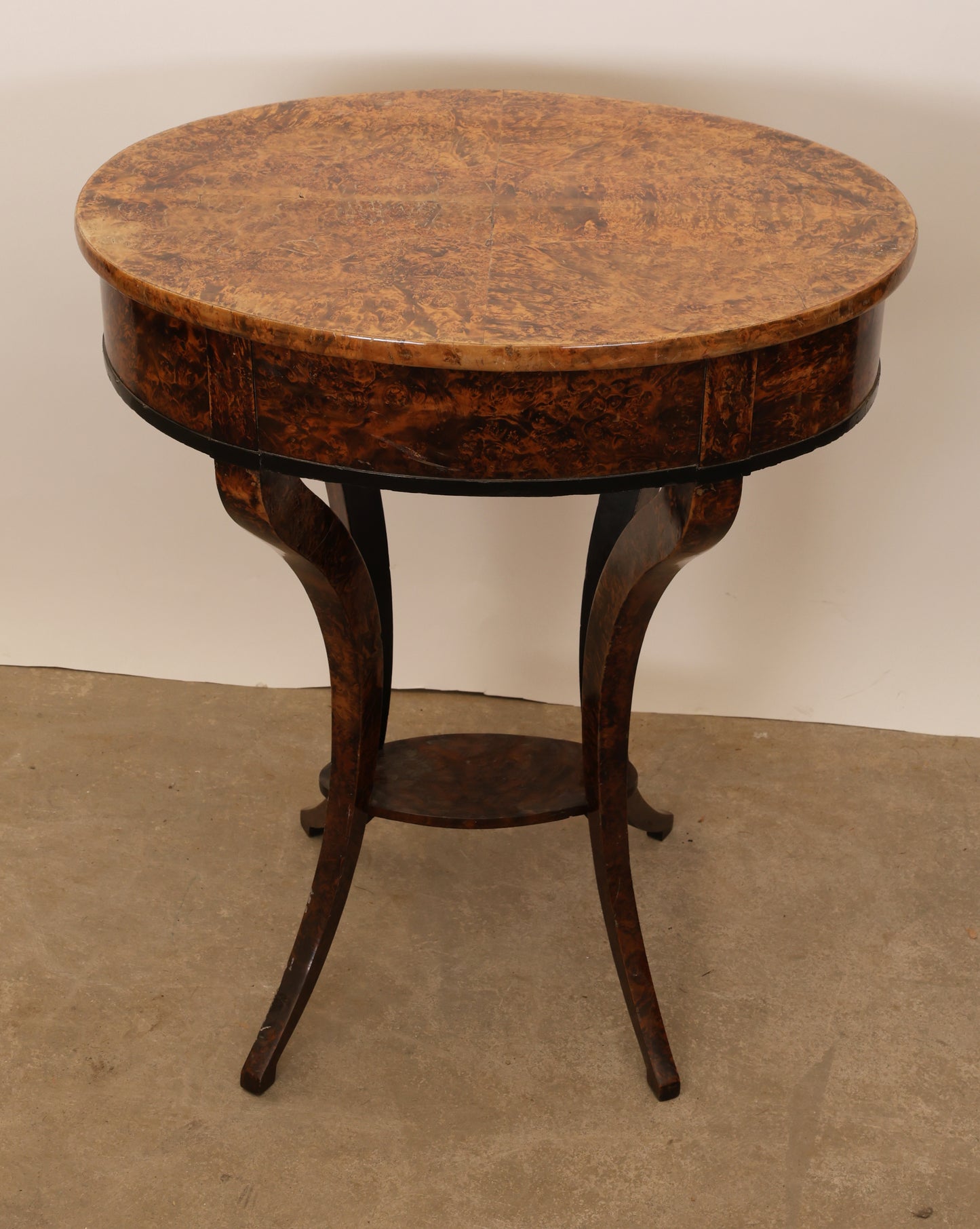 The back of an 1800s antique table in veneered root.