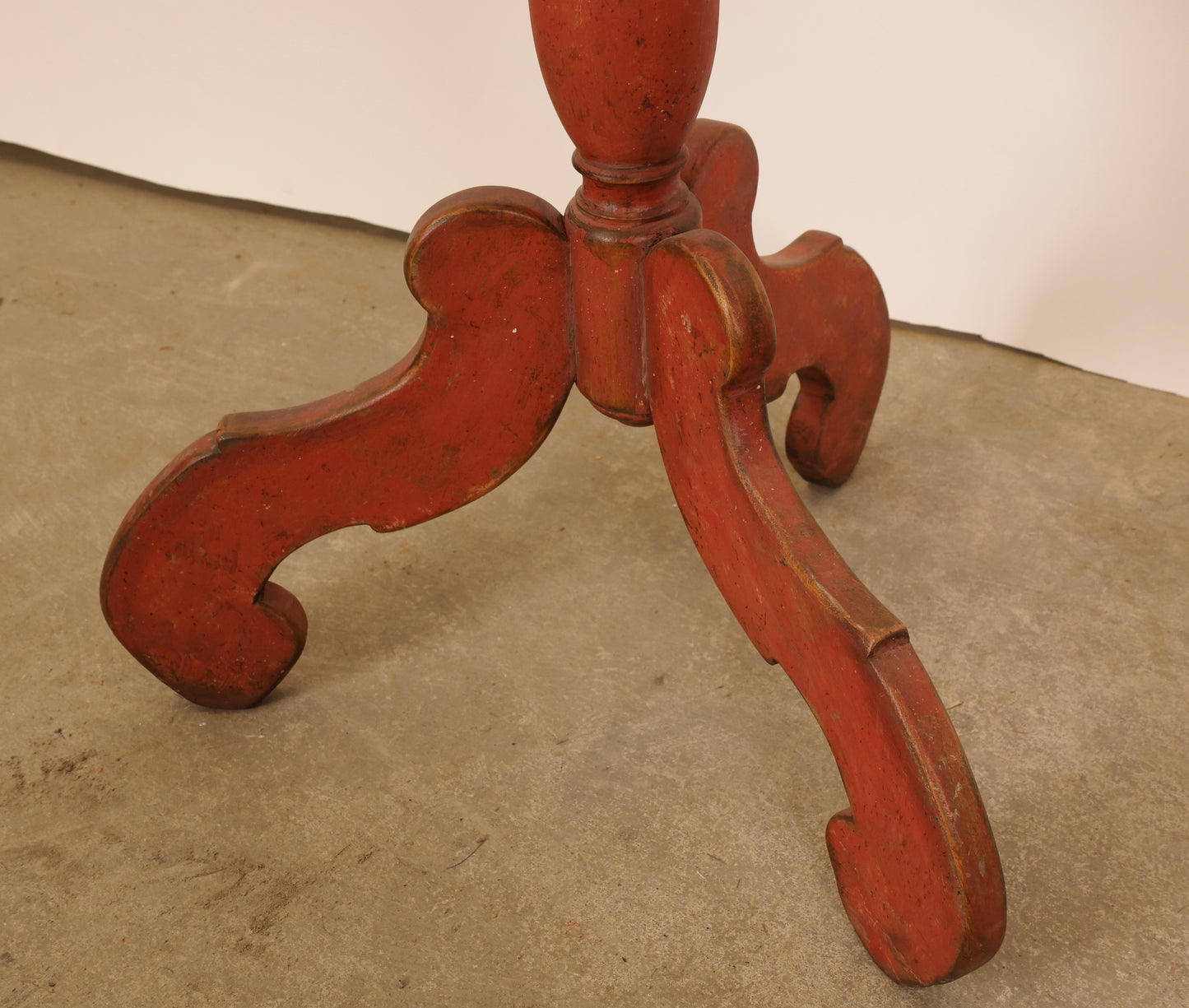 The base which is painted in red hue of an 18th Century Baroque Marbled Folding Table