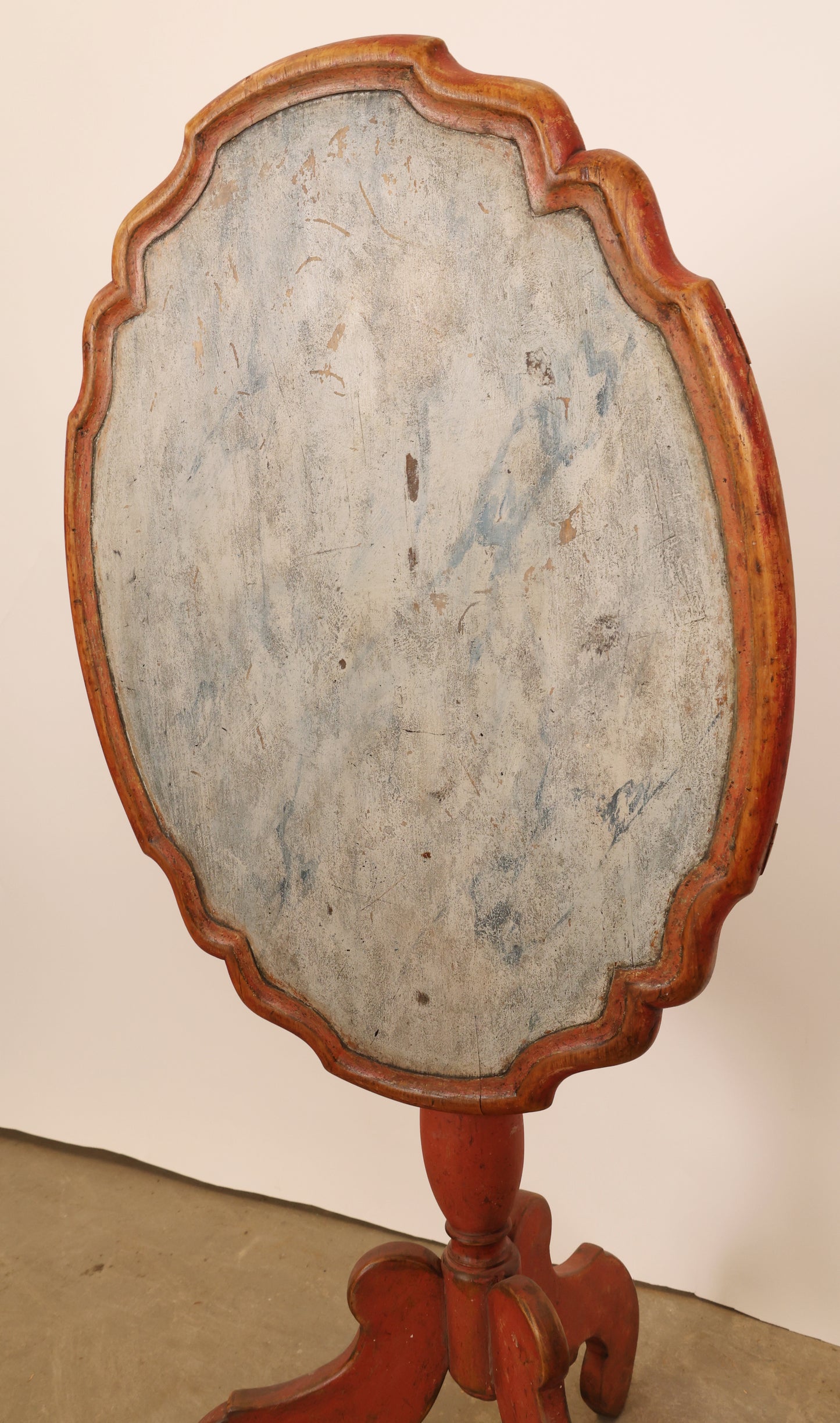 The contoured and marbled table top of a 18th Century Baroque Marbled Drop-leaf Table