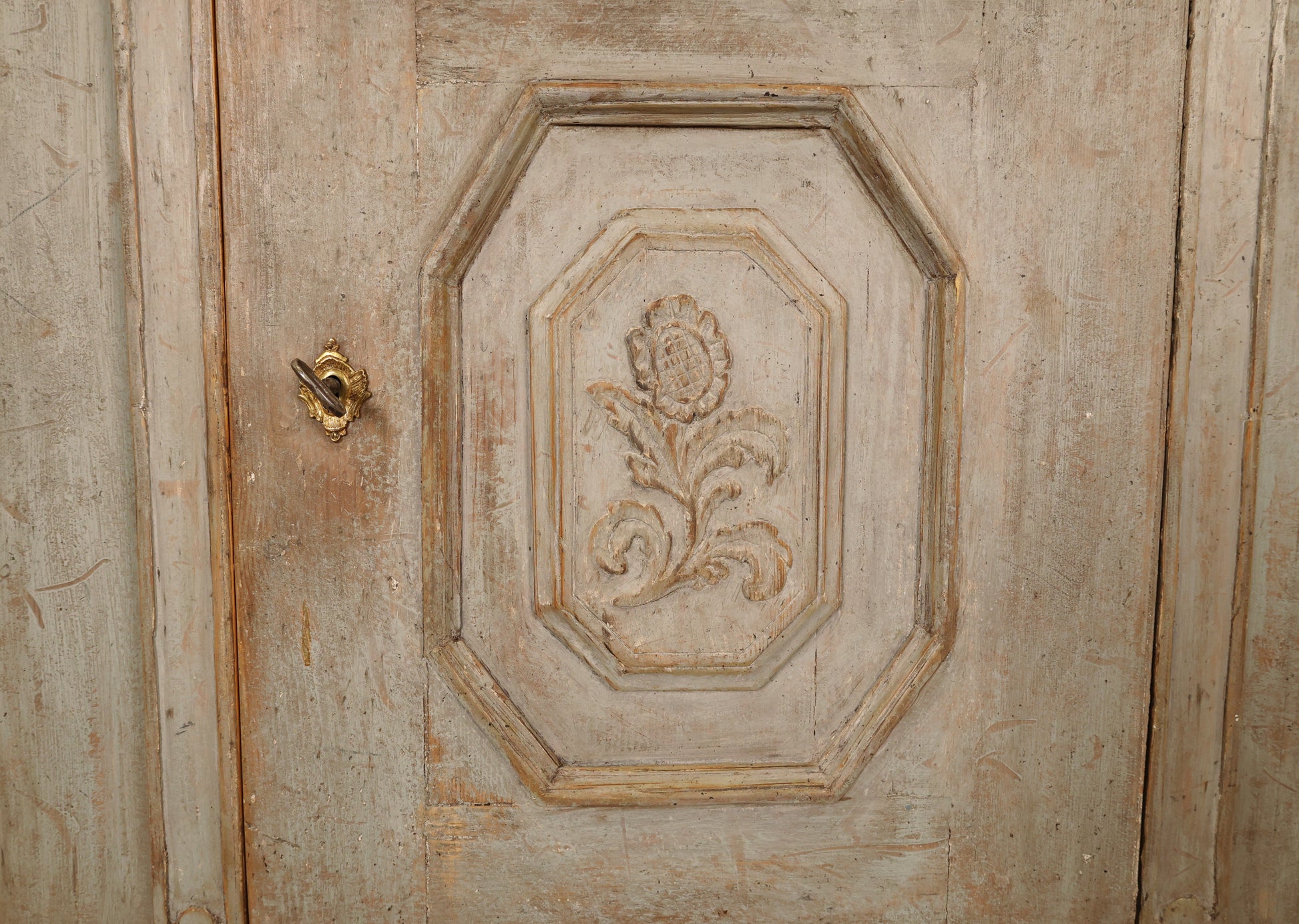 Detail photo of a carved flower on the lower section door of an 18th Century Rococo Display Cabinet
