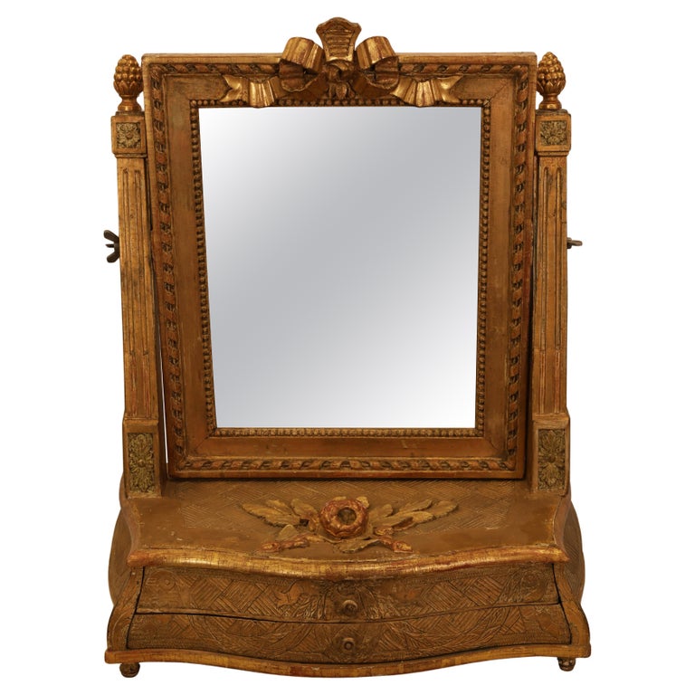 18th Century Gustavian Vanity Mirror For Sale. The chest mirror has two drawers. The dressing mirror is gilded and has rose, rosette and pinecone decorations.