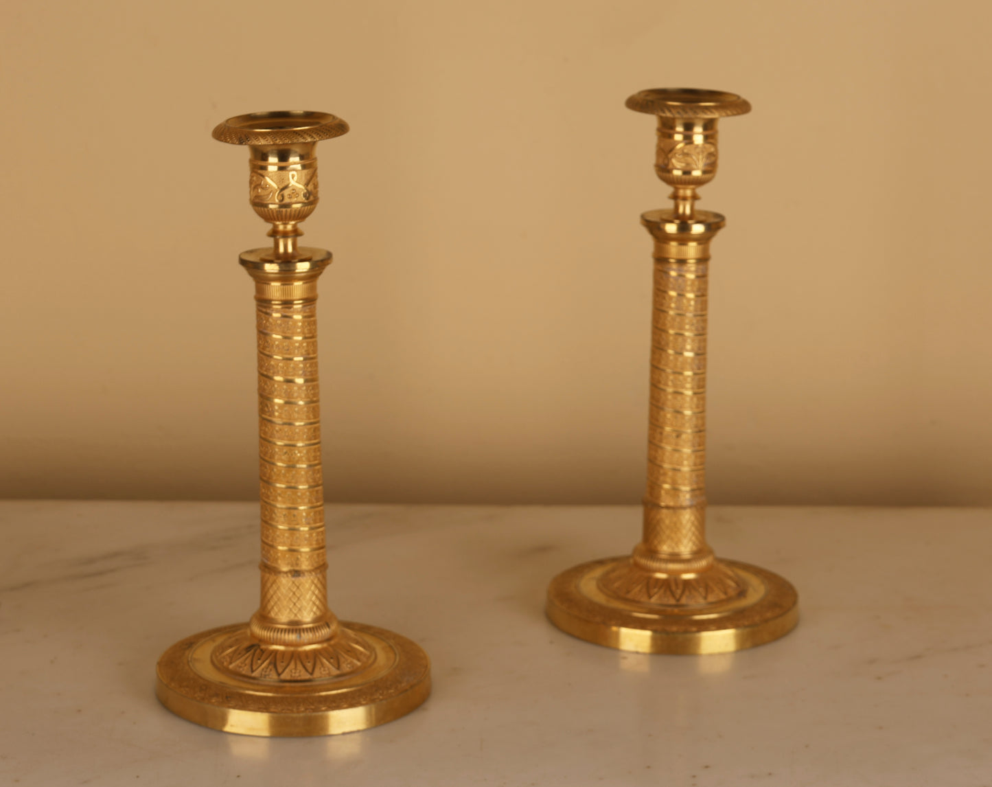 Pair of antique candlesticks in burnished gilded bronze.