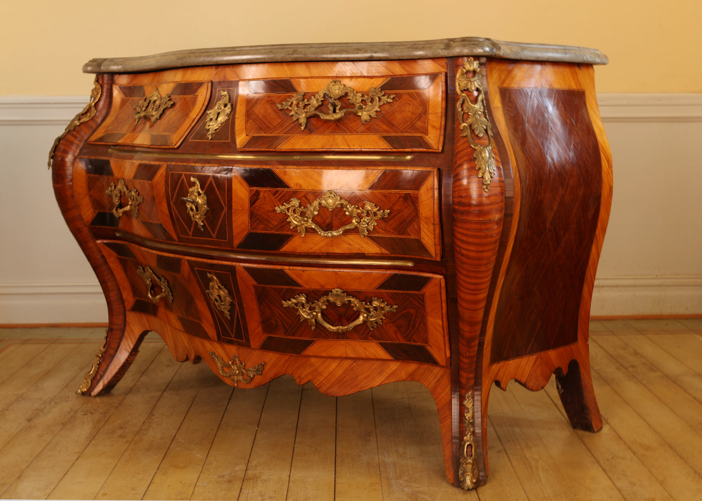Side view of a Rococo furniture chest of drawers.