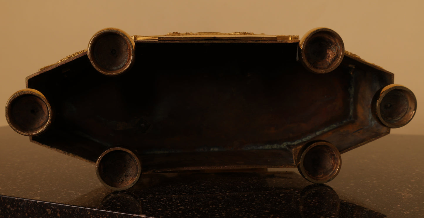 Underneath an antique art object from the Gustavian Period in the form of an Mantel Clock with Putto.