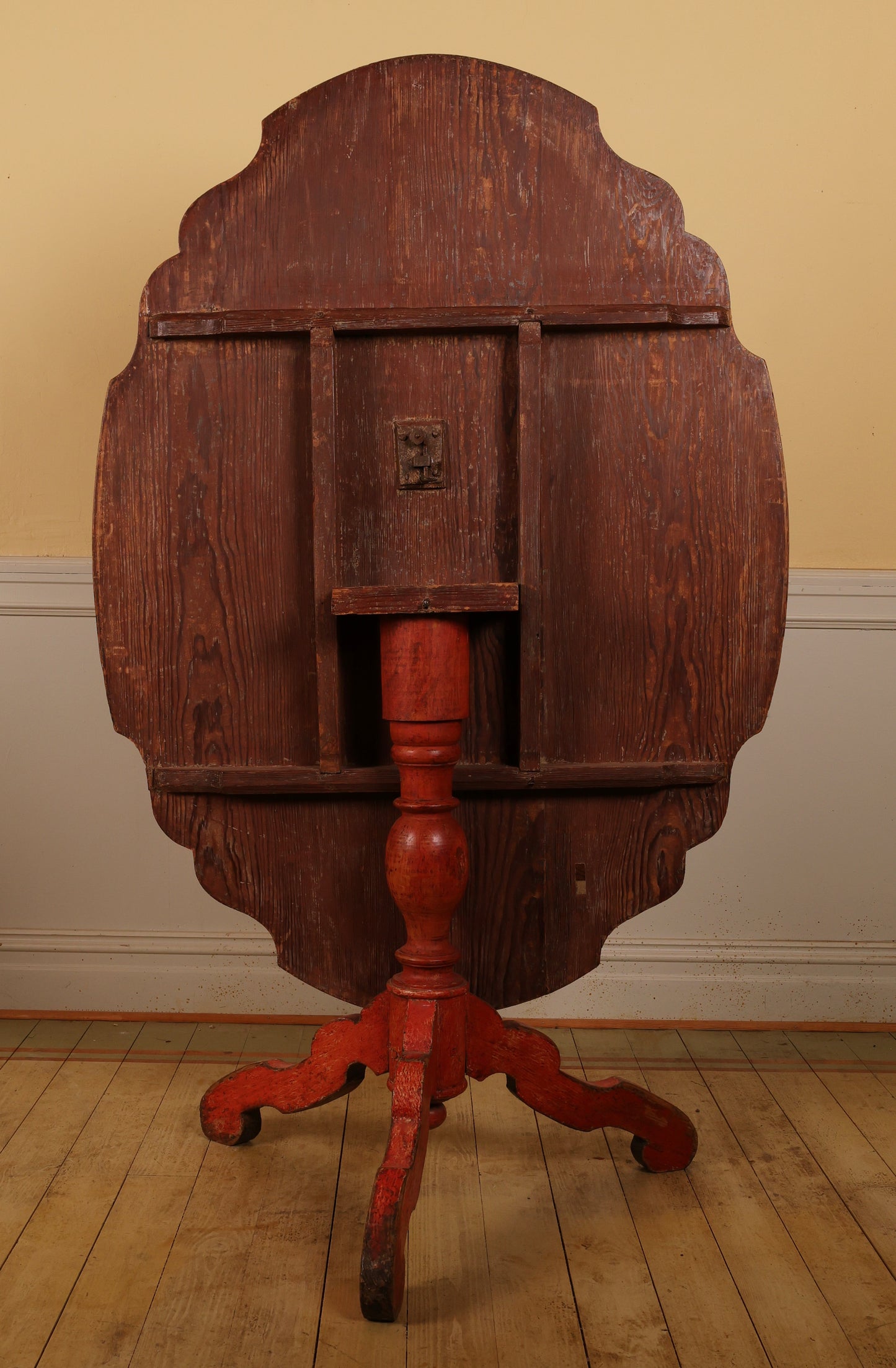 An antique folding table from behind.