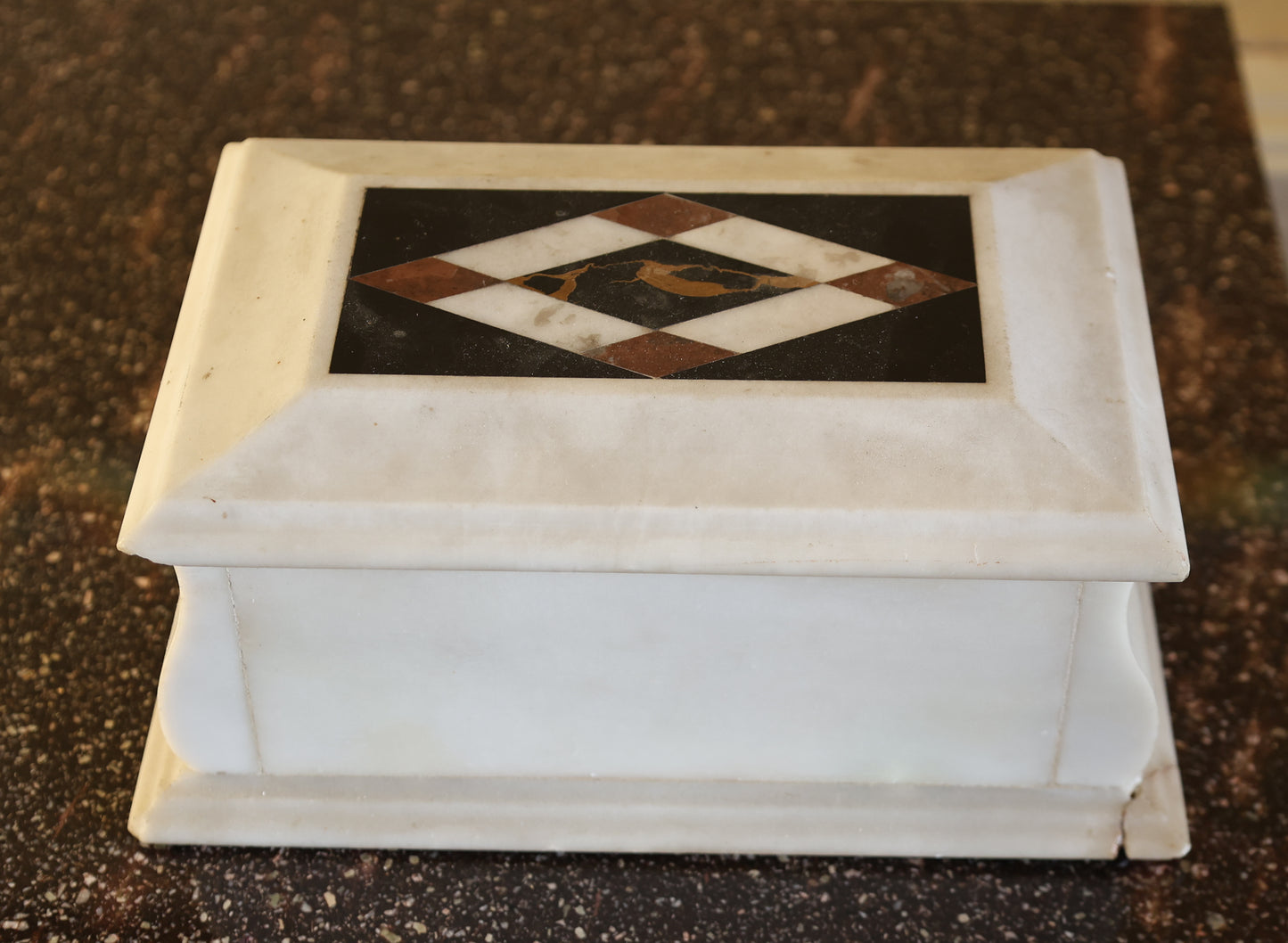 The back of a lidded box in marble