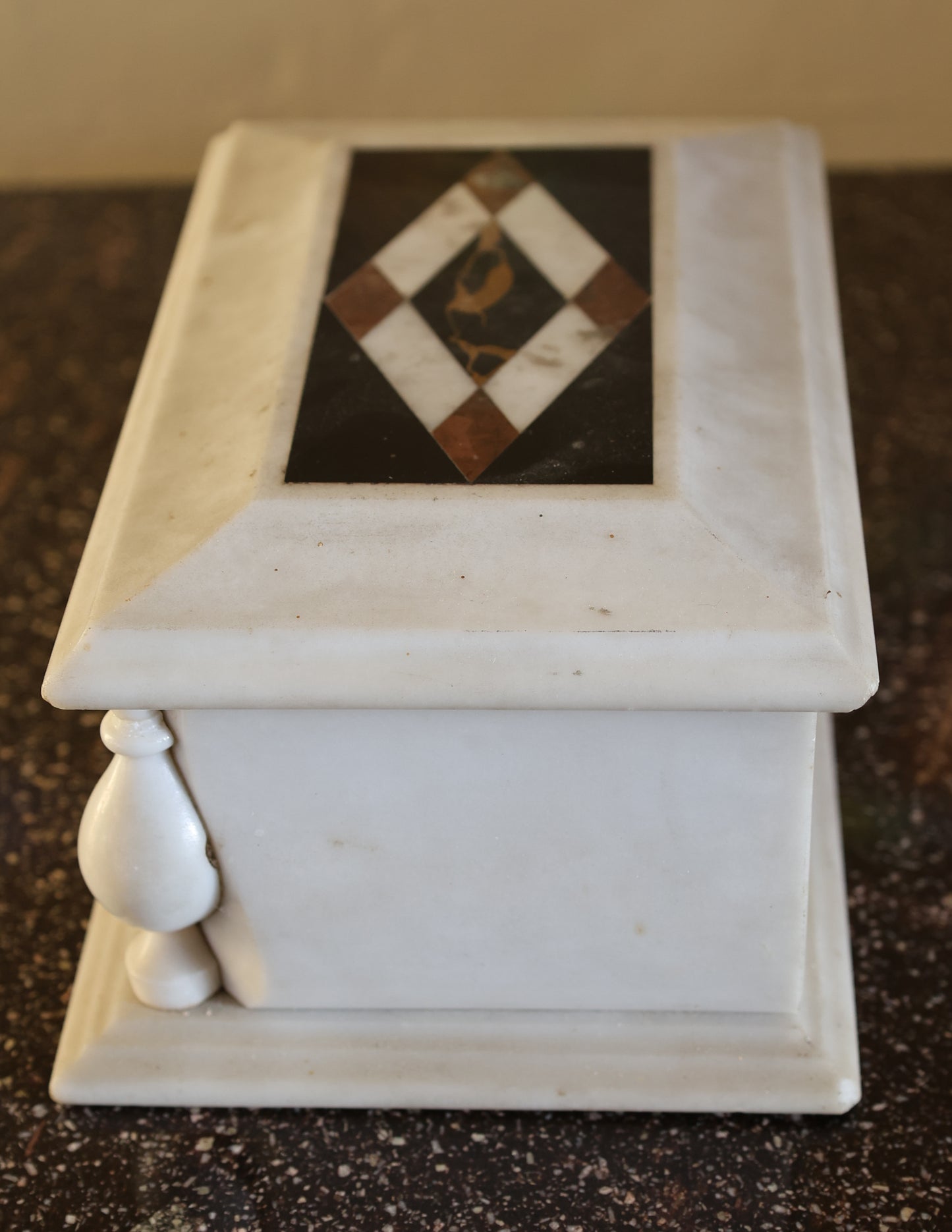 Side view of a lidded box in marble