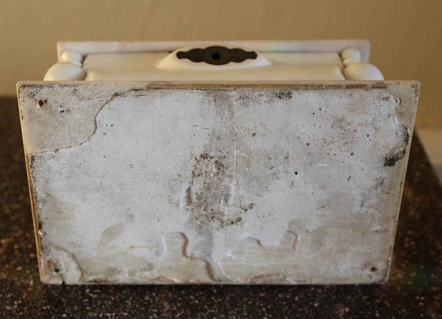 Underneath a lidded box in marble