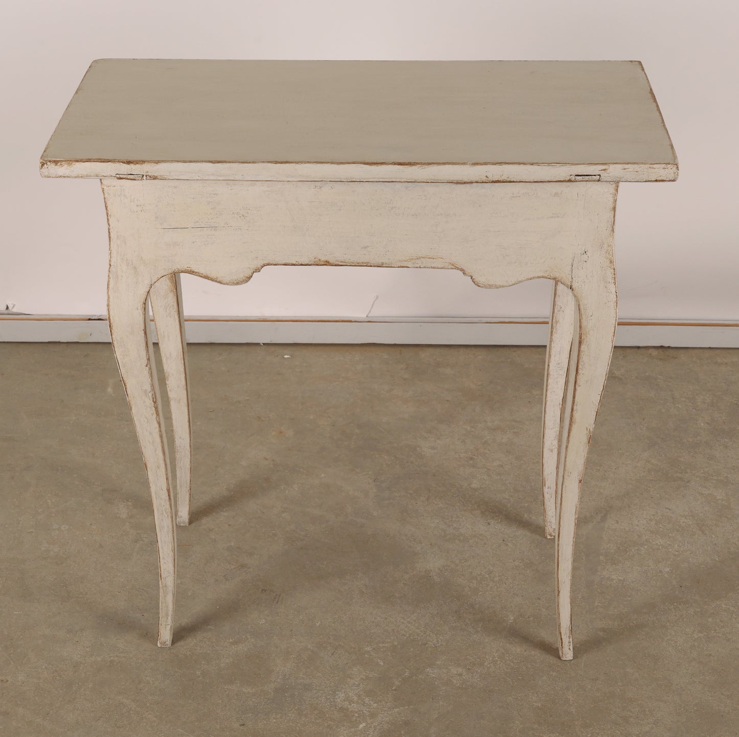 The back of an 18th Century Rococo Table in grey color