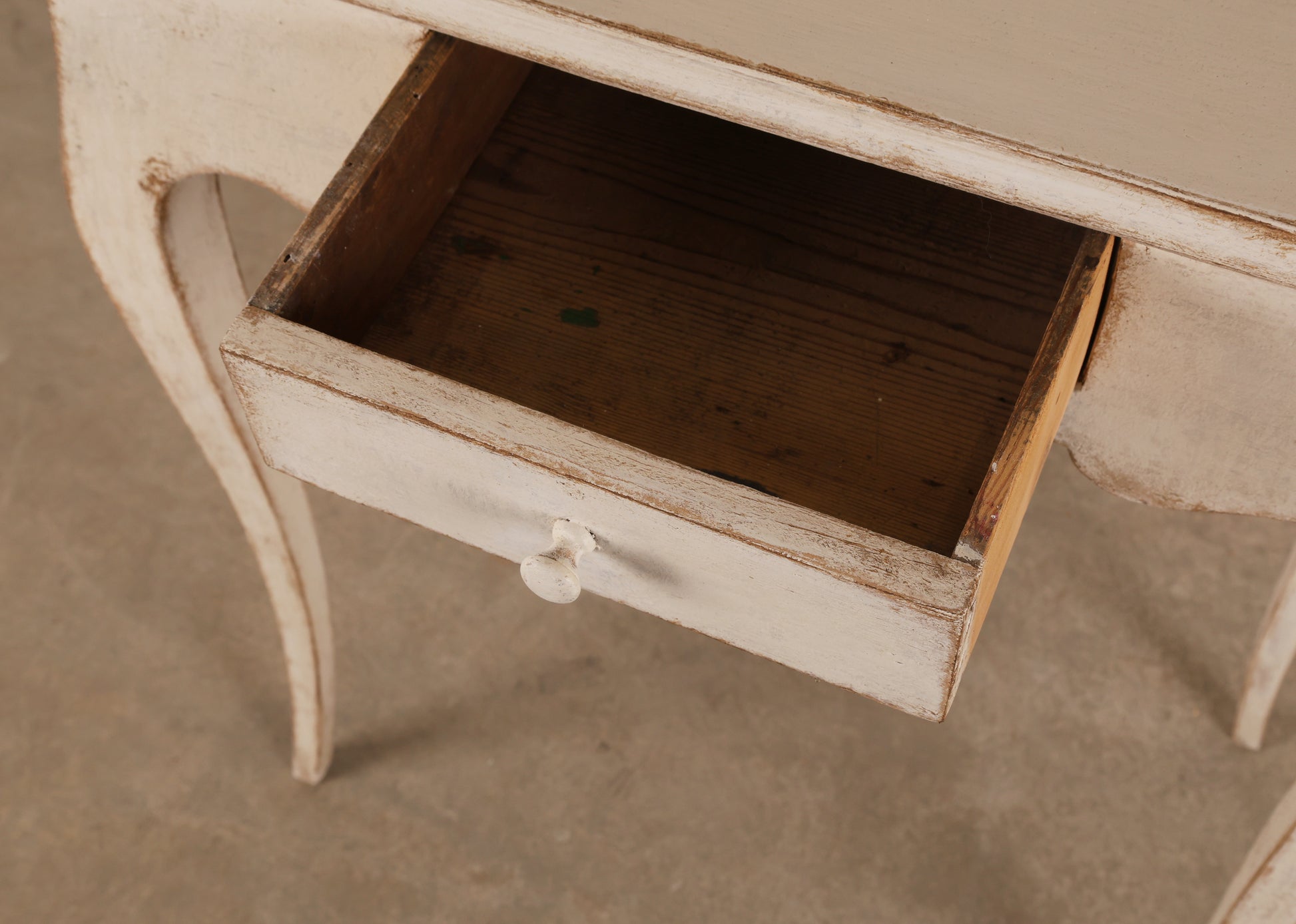 Close up of opened drawer of an 18th Century Rococo Table in grey color