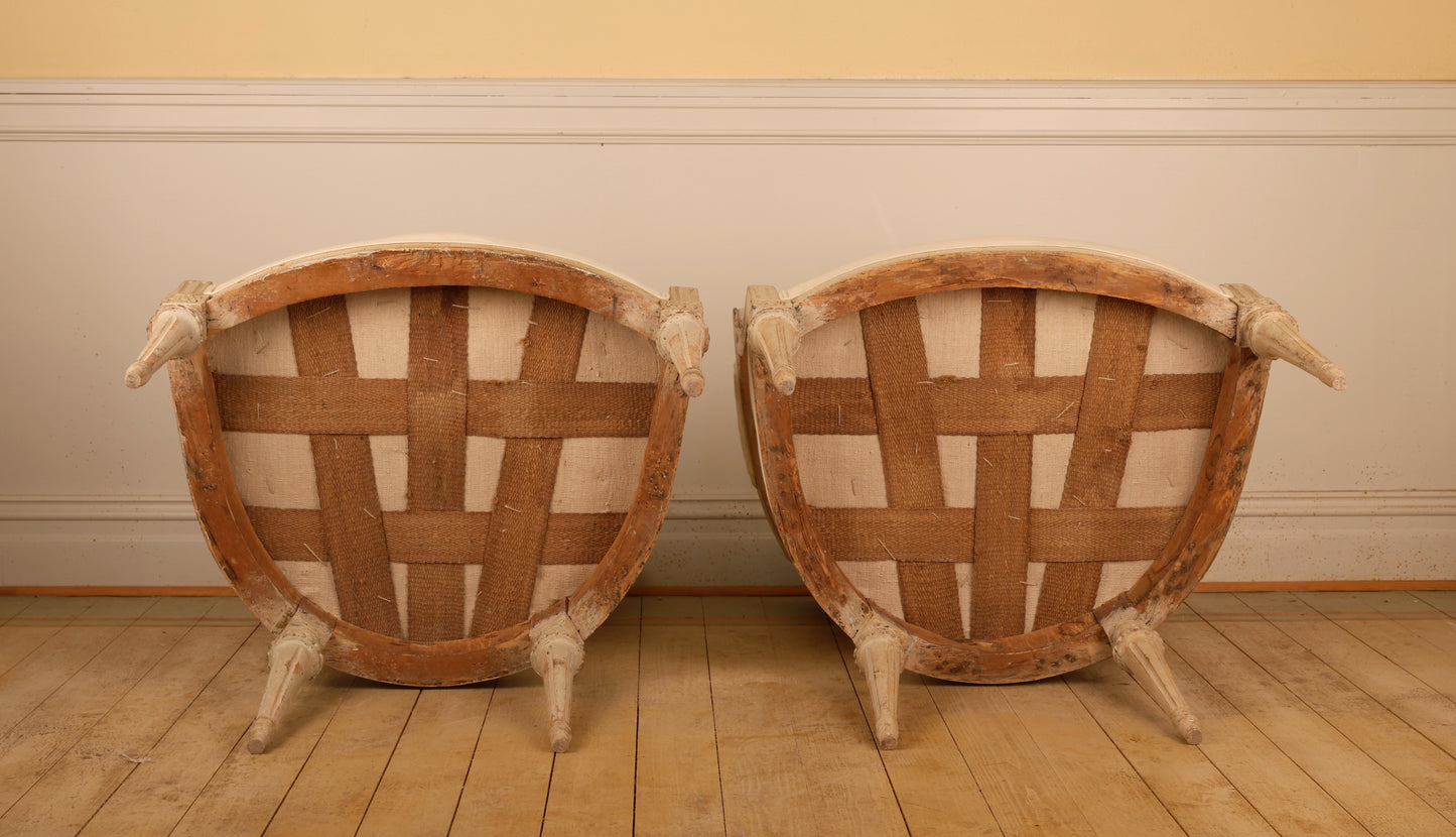 A pair of antique gustavian armchairs. Showing how the antique chairs look underneath.