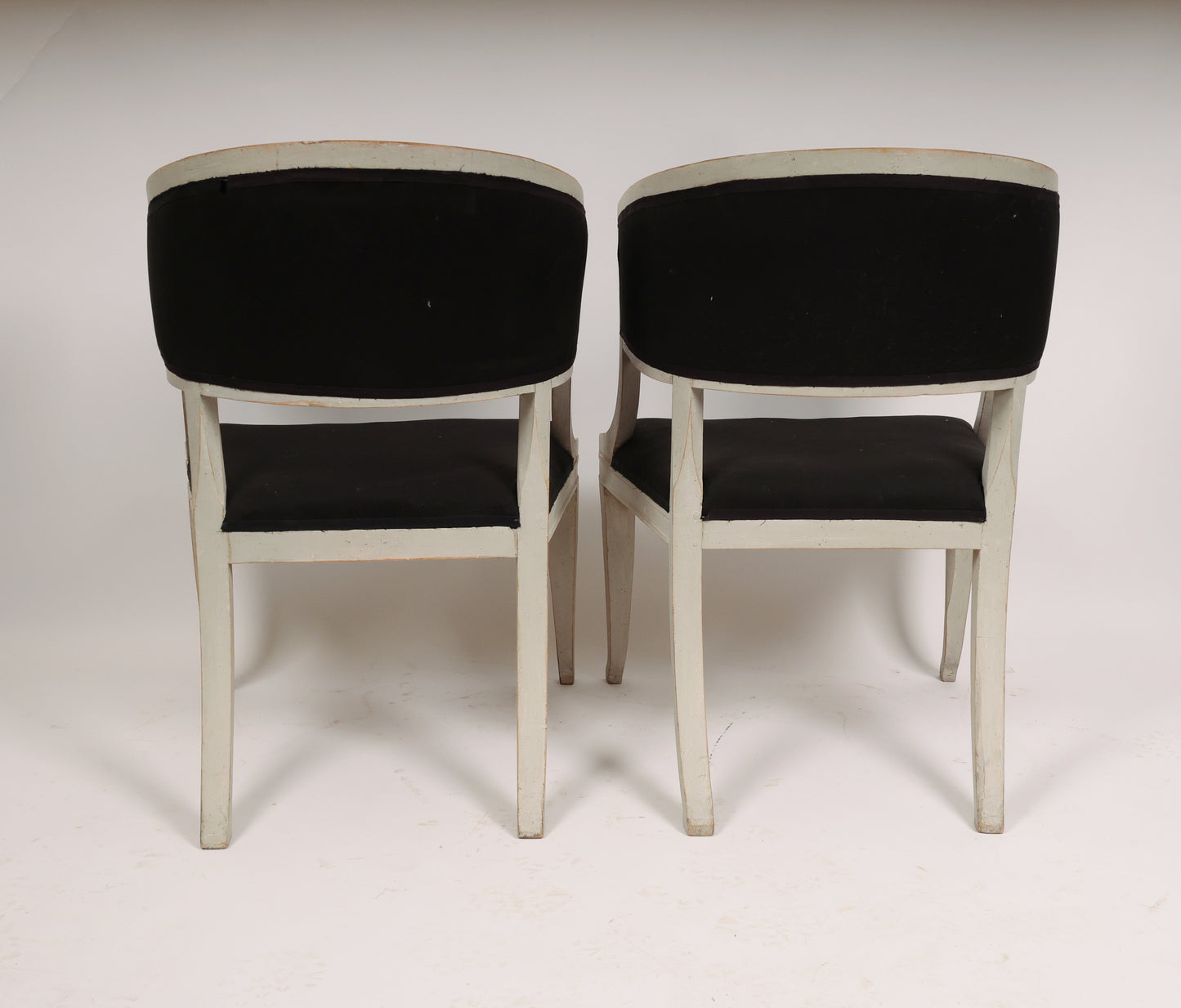 The back of Pair of Early 19th Century Empire Armchairs in grey color with black upholstery