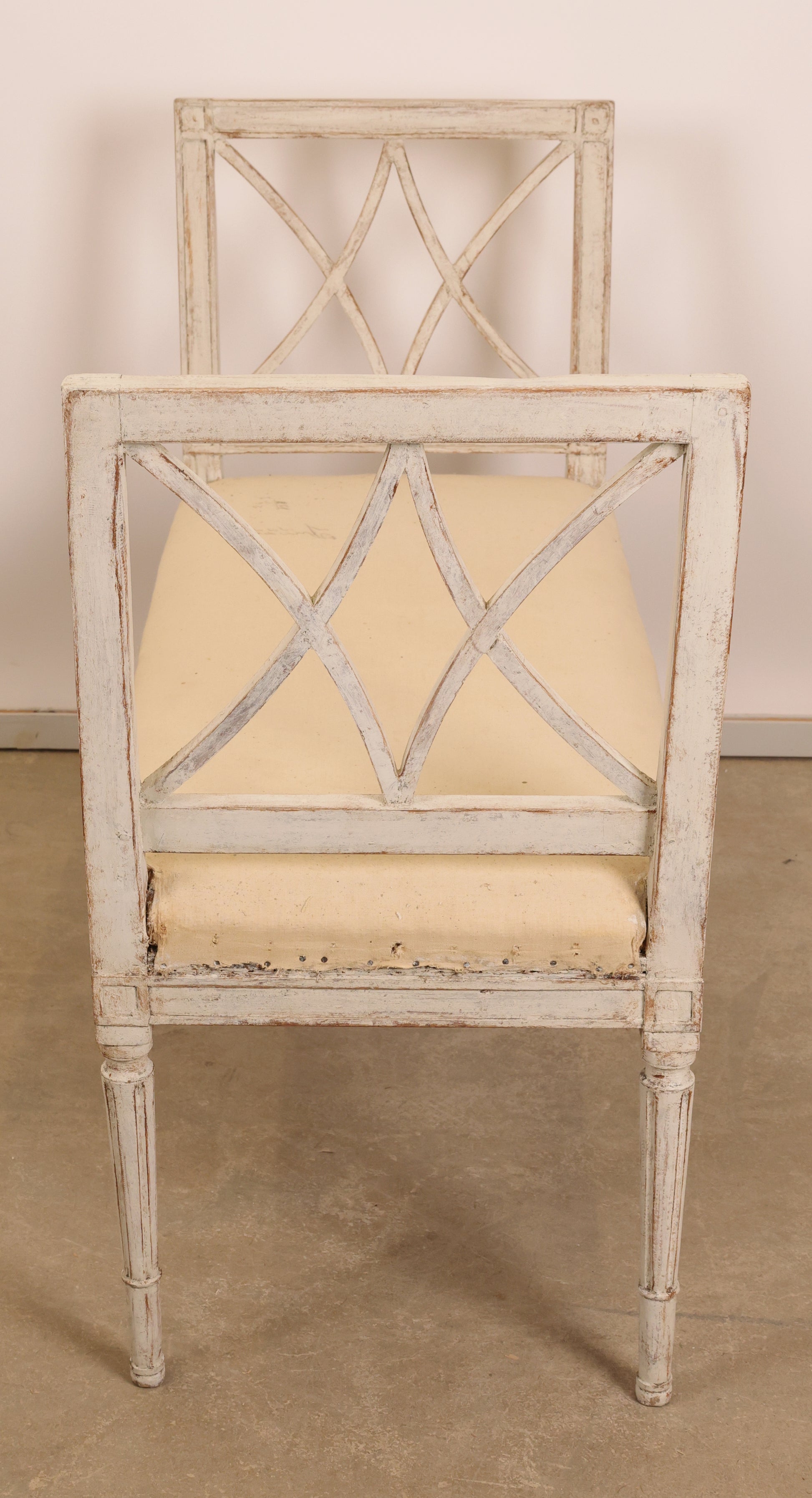 A white gustavian bench from the 19th century from the side