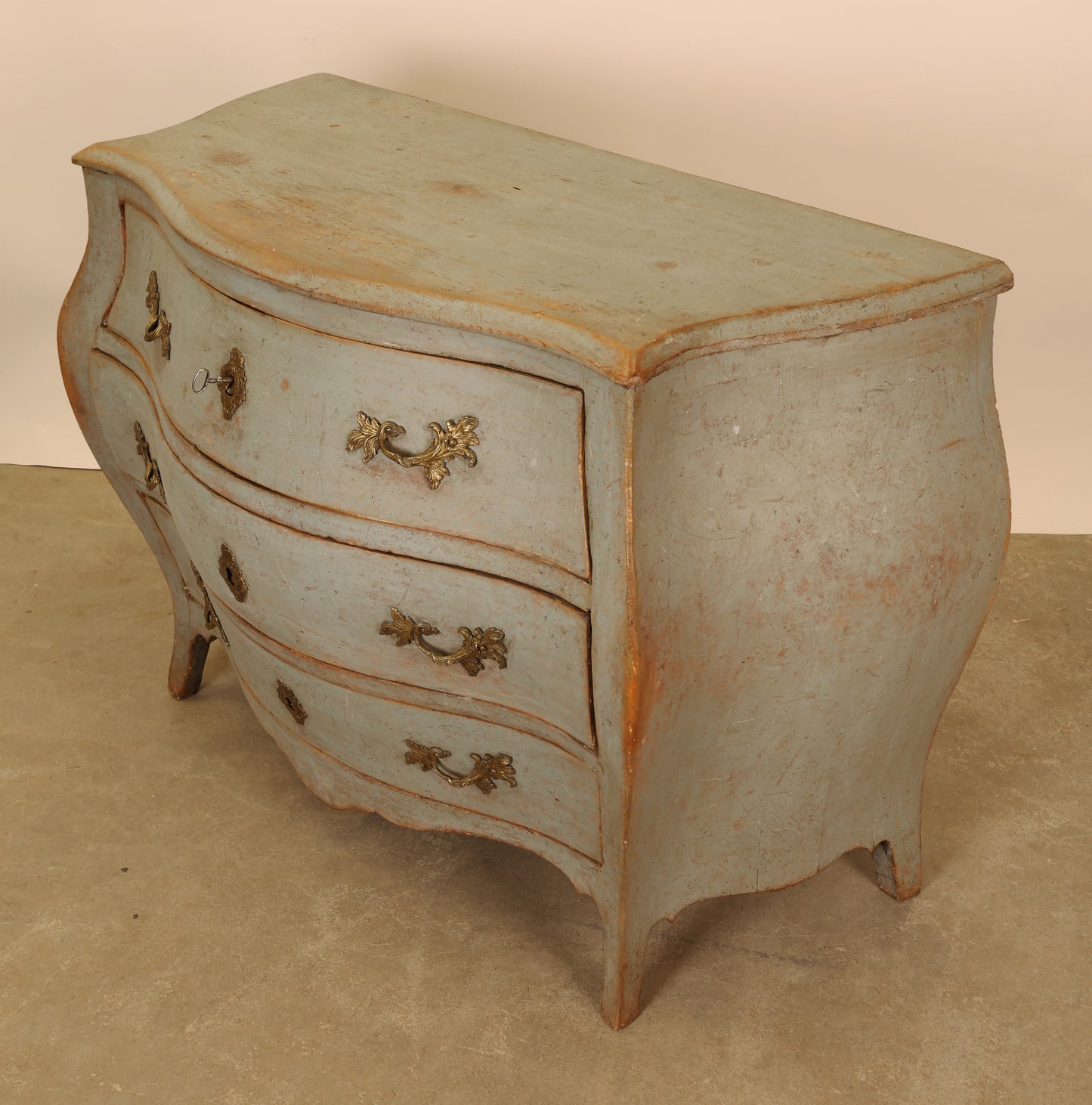 A blue rococo dresser.