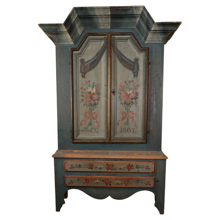 Early 19th Century Cabinet in a beautiful blue color and flowers. White background.
