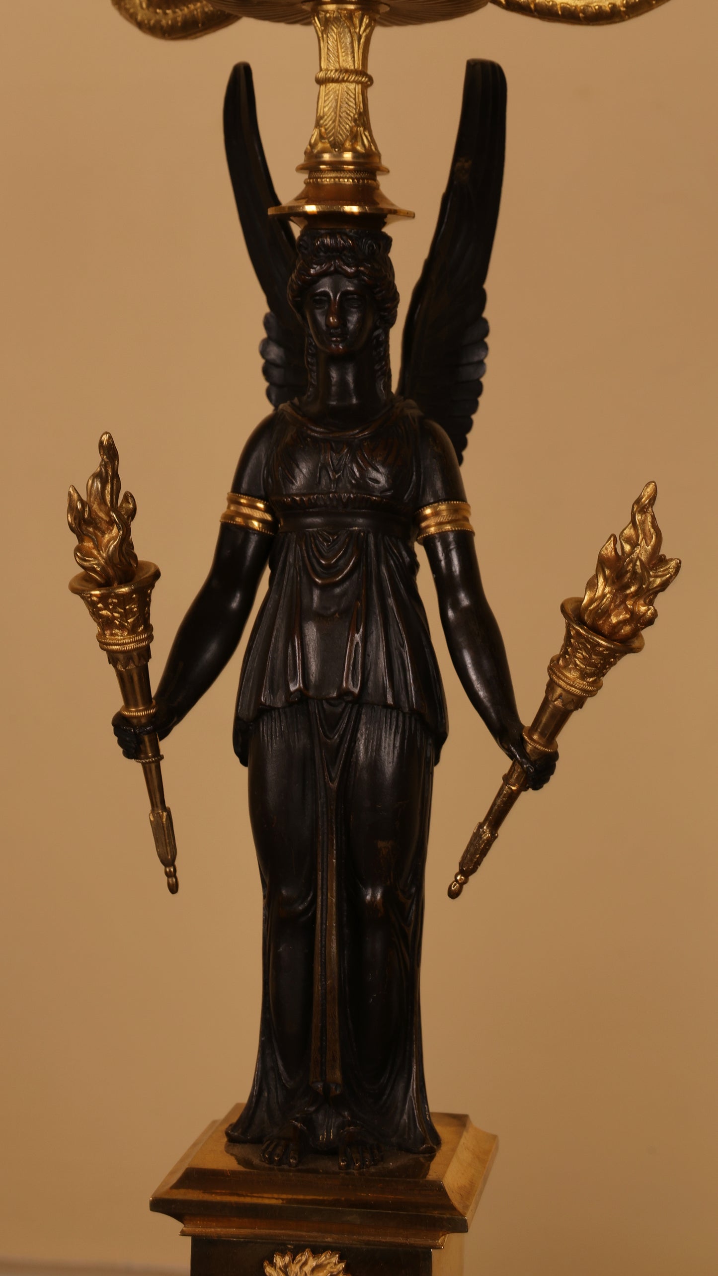 Close up of a goddess on an antique candelabra.