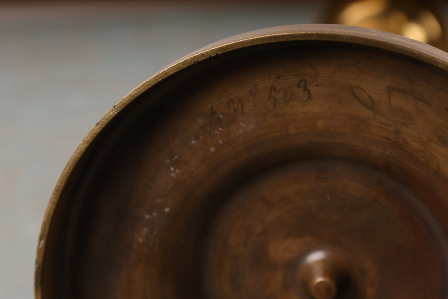 The signature on an antique candleholder from the Empire period.