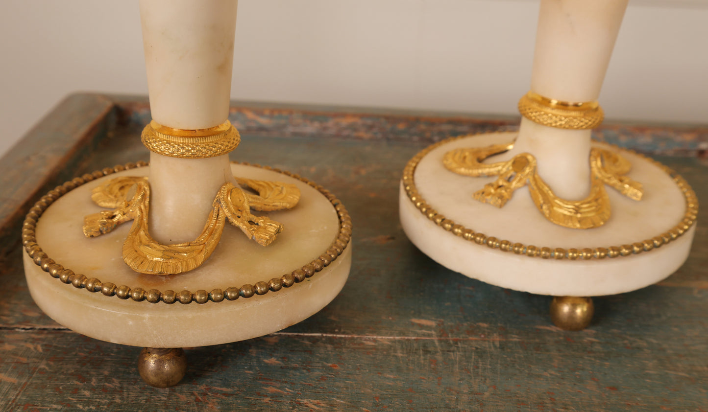 The base of a pair of louis xvi carrara marble candlesticks