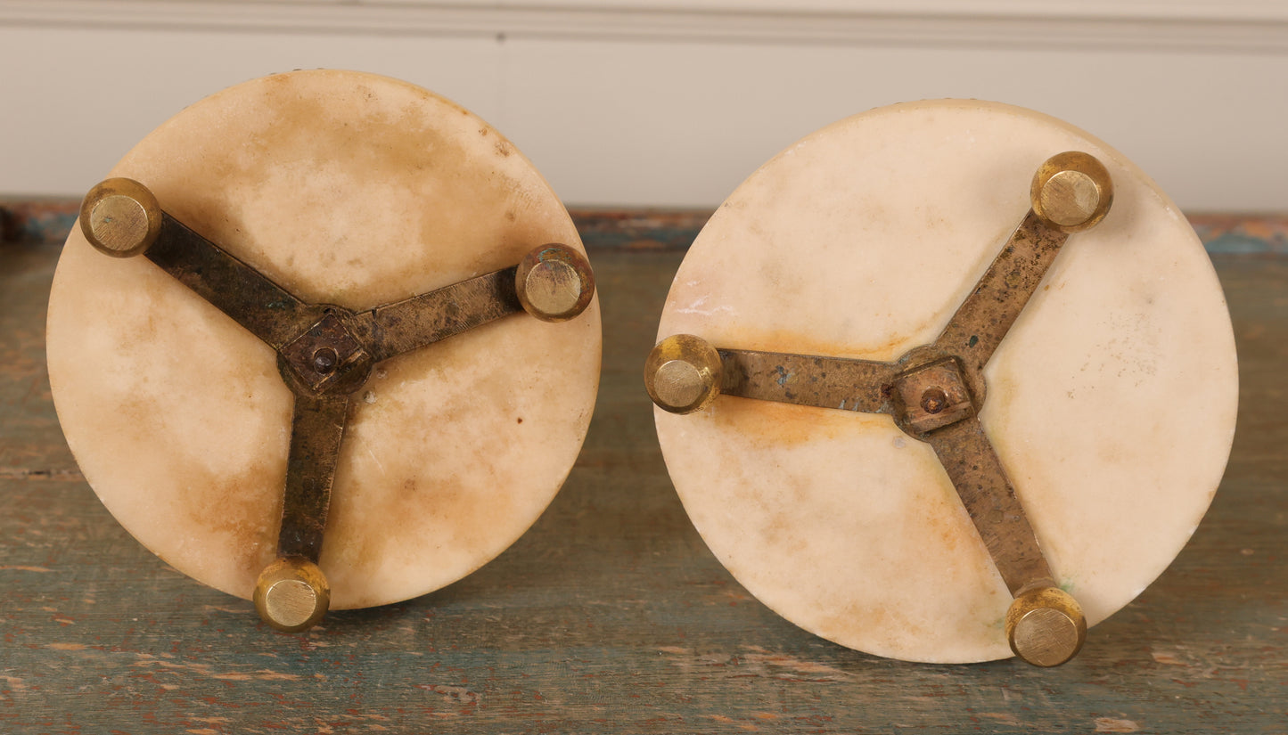 Underneath a pair of louis xvi carrara marble and fire-gilded bronze candlesticks.