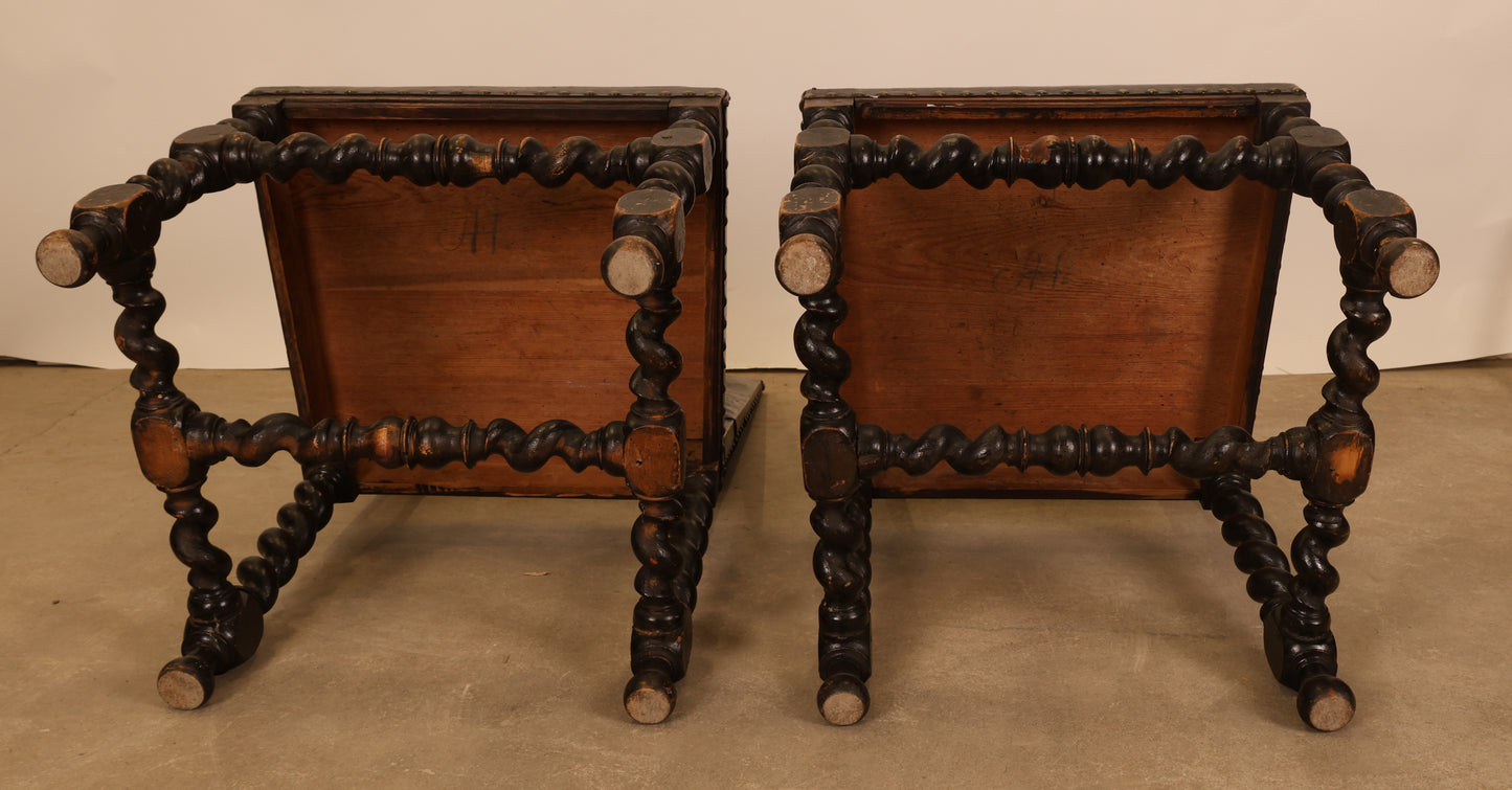Underneath a pair of antique Baroque chairs.