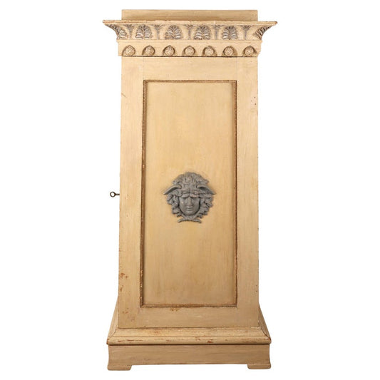 A gustavian column cabinet from the 18th century. The cabinet is adorned with blue medusa heads on each side.
