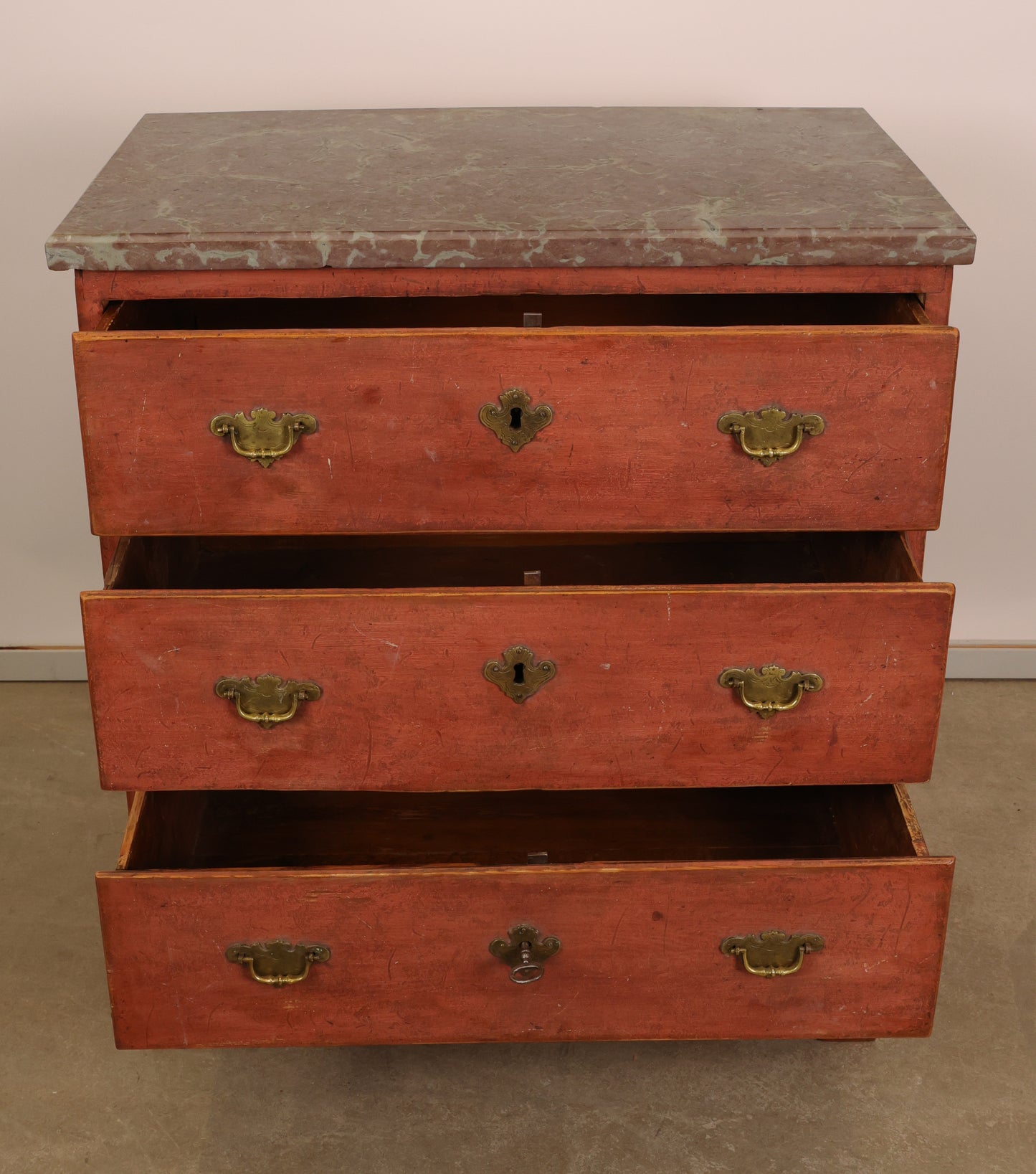 Opened drawers of an Baroque Chest of Drawers in Red color