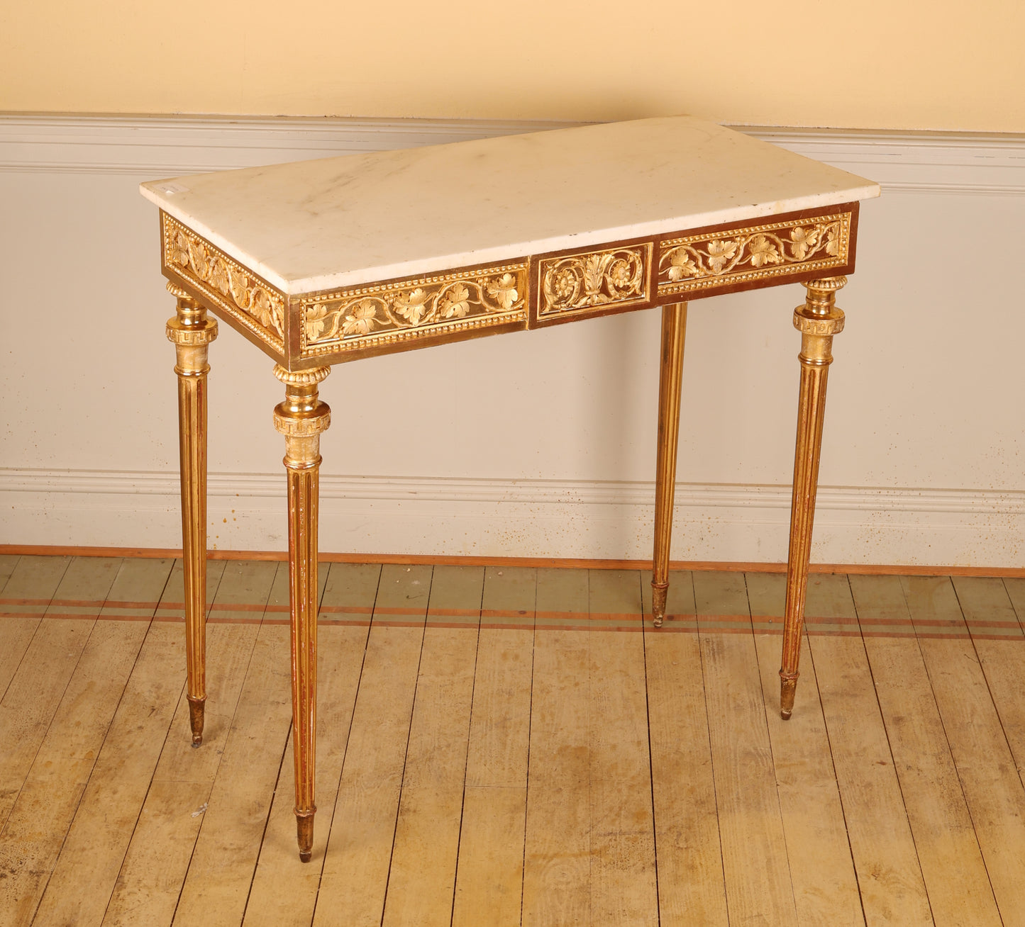 A high-quality Gustavian console table with gold leaf made by Pehr Ljung in 1770. The table features beautifully carved leaf decorations in relief and retains its original Carrara marble top.