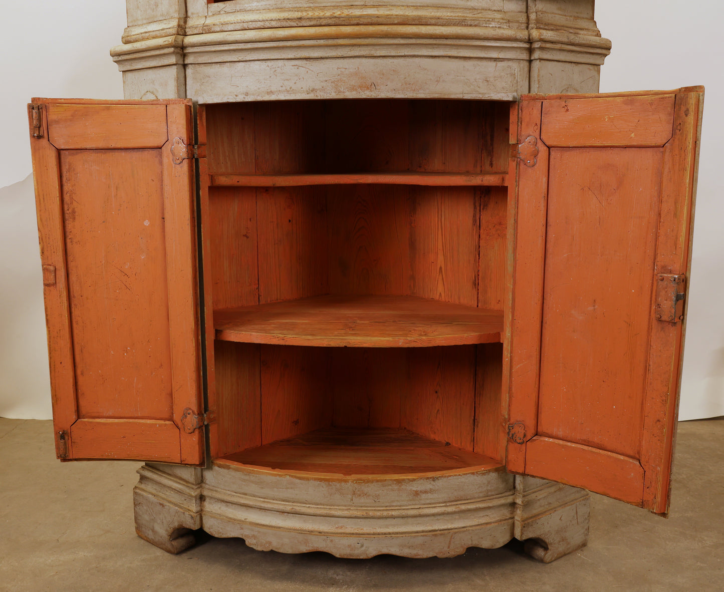 Opened doors on an antique corner Cabinet