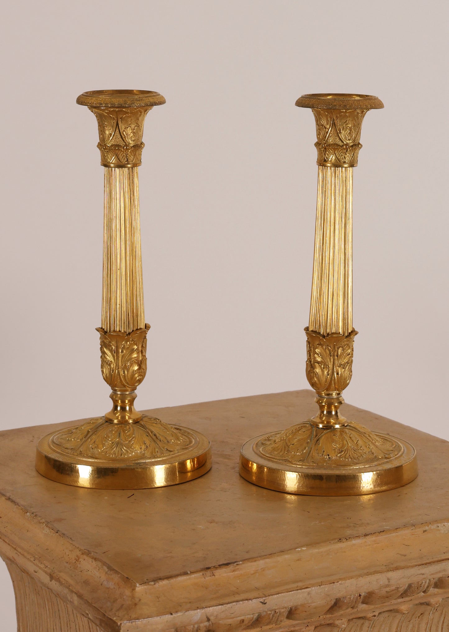 Empire candleholders in fire gilded bronze for sale.