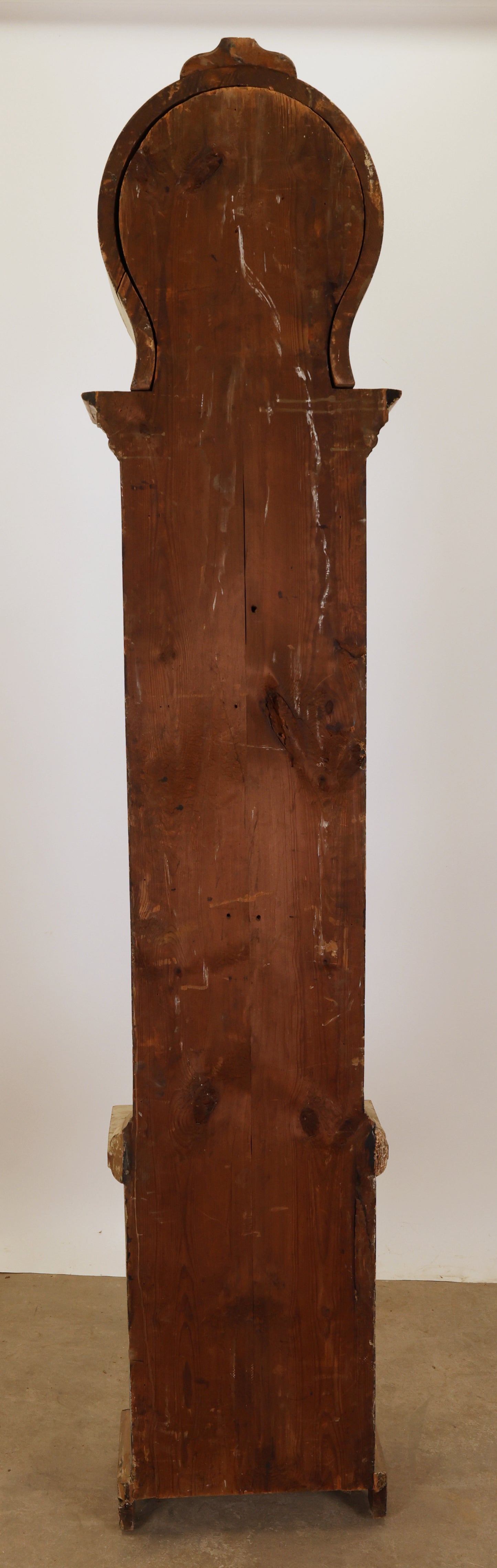 Antique longcase clock from behind.