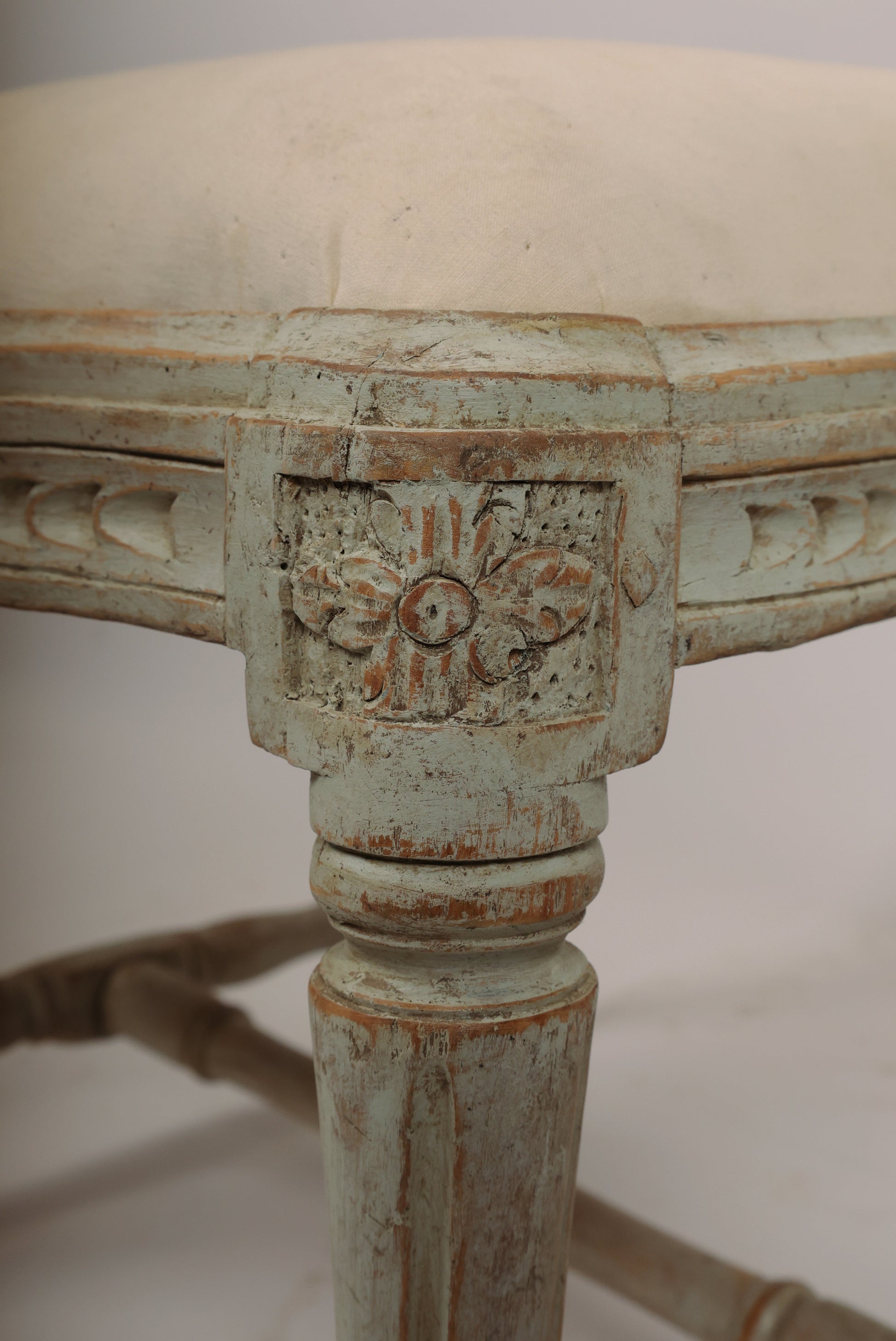 Carved corner floron on a Gustavian stool