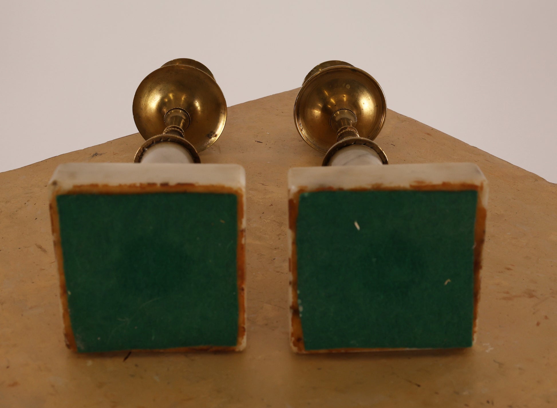 Underneath an antique pair of gustavian candlesticks in marble.