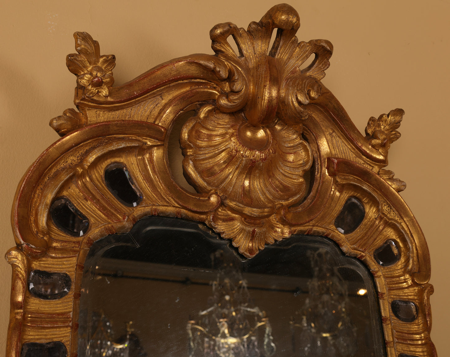 Close up of a gilded rococo mirror from the 18th century.