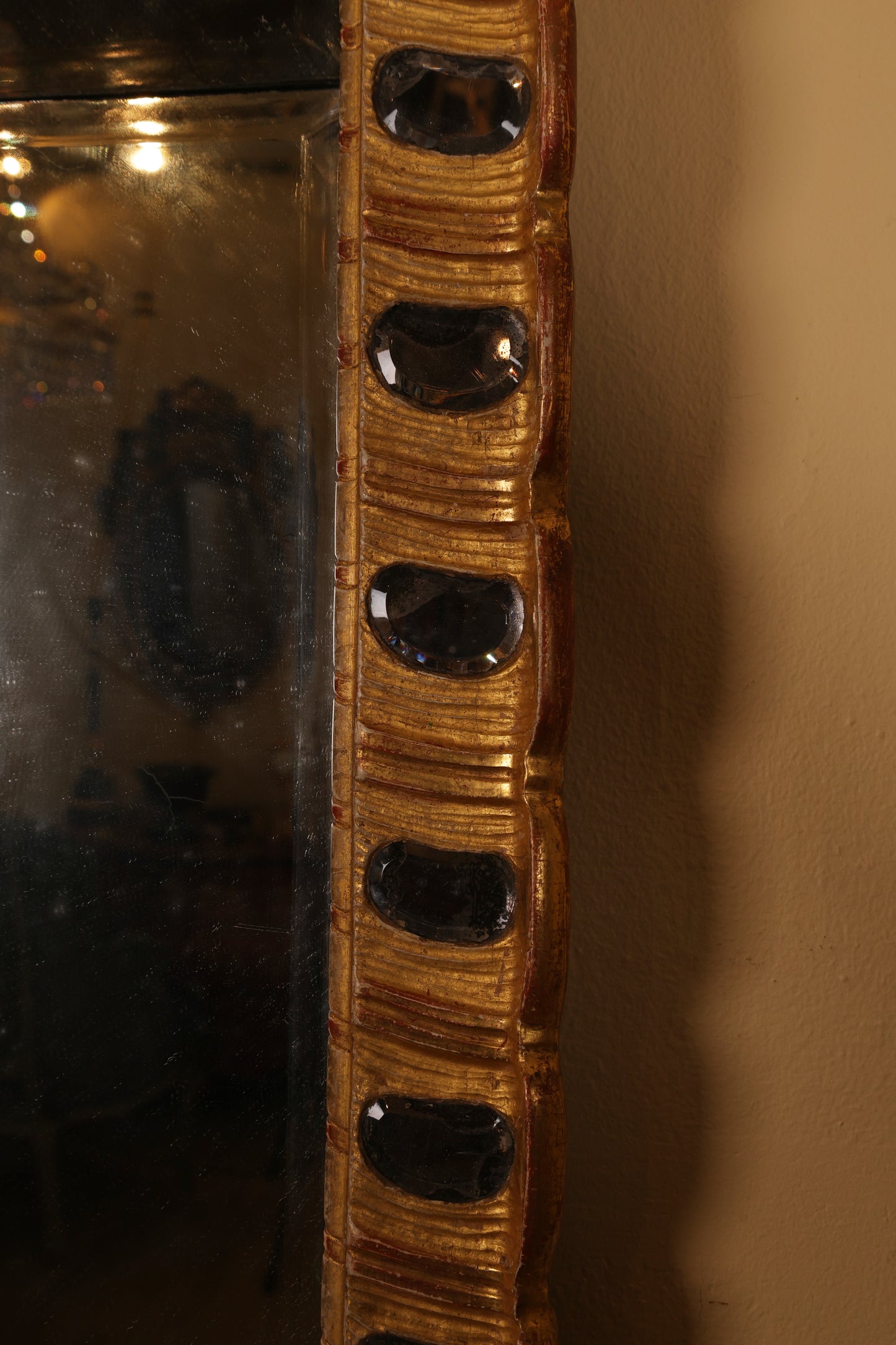 The lenses on a gilded rococo mirror from the 18th century.