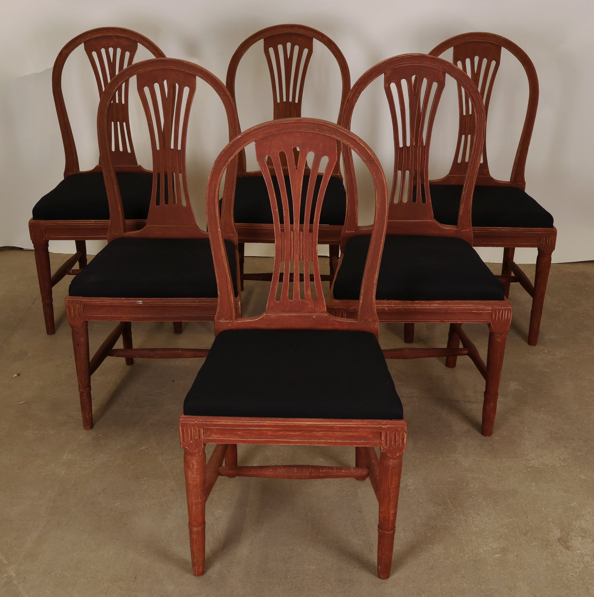 Set of six red Gustavian chairs for sale.