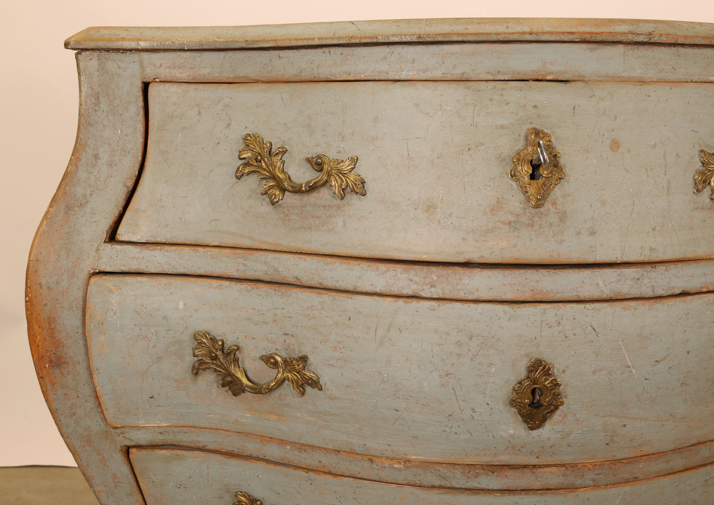 Close up photo of a blue Rococo dresser.
