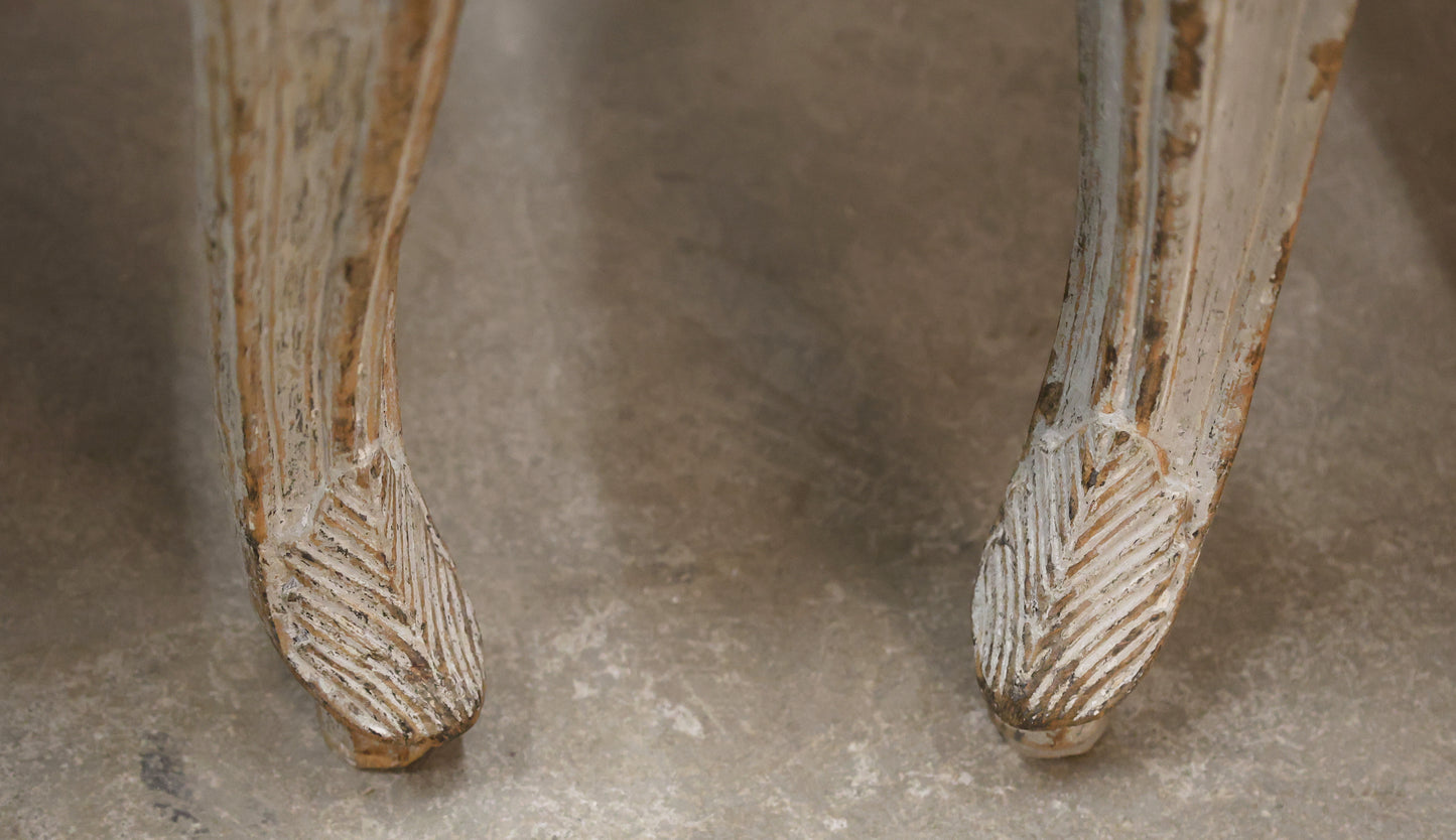 Carved details on a pair of Rococo armchairs.