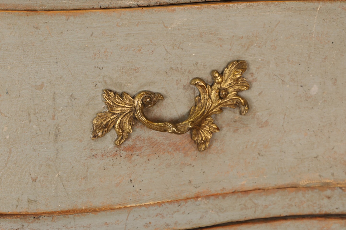 Gilded details on a Rococo chest of drawers.
