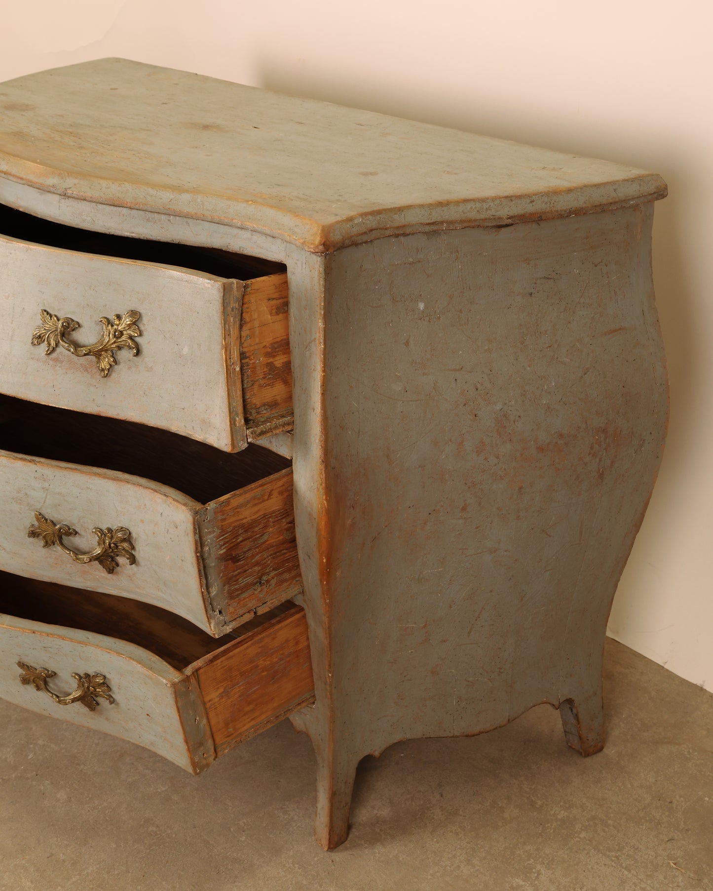 A rococo chest of drawers from the 18th century, side view.