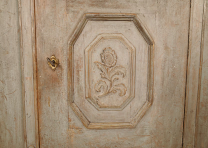 Detail photo of a carved flower on the lower section door of an 18th Century Rococo Display Cabinet 