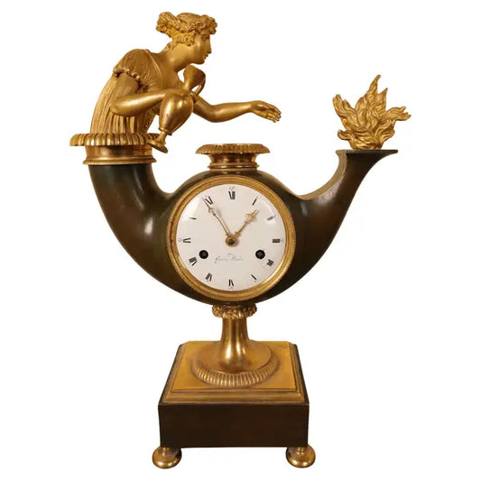 Early 19th Century Mantel Clock signed Gustaf Undén with white background. Features a burnished gilded goddess reaching towards a fire.