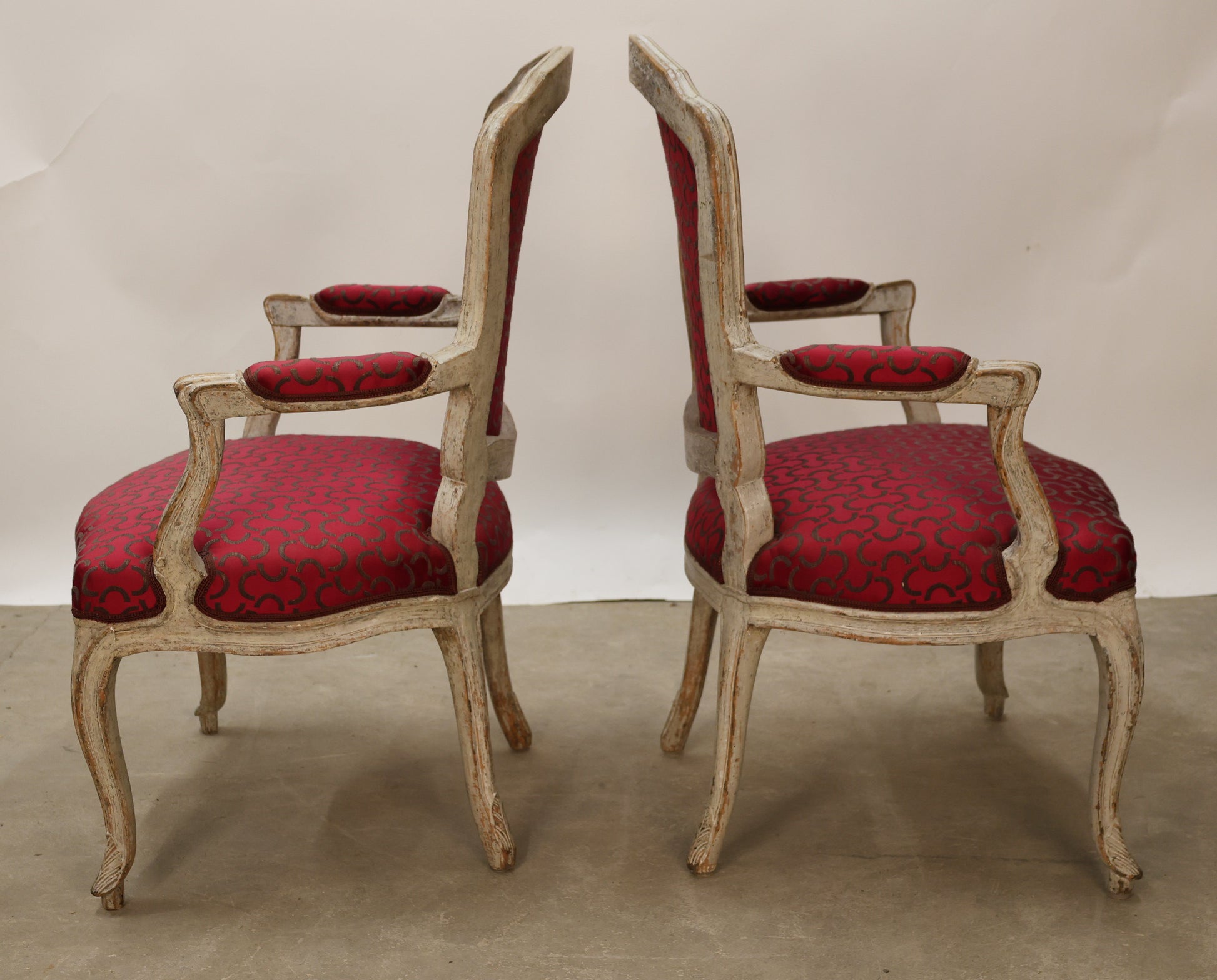 Side view of a pair of Rococo armchairs.