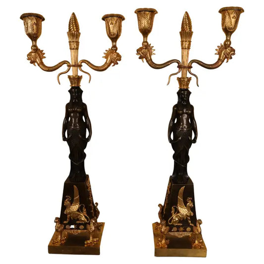 Antique candelabras with mythical creatures such as sphinxes and dragons.