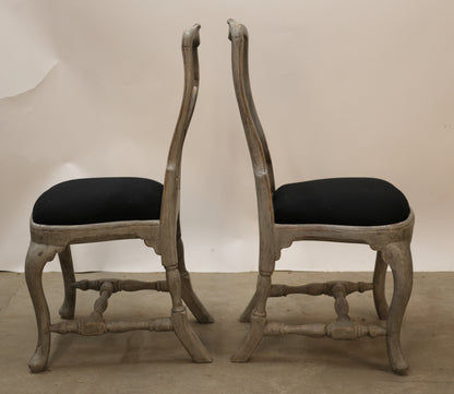 Two antique Rococo chairs as part of a set of eight.