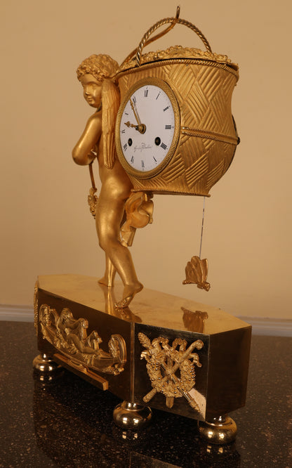 An antique mantel clock in burnished-gilded bronze.