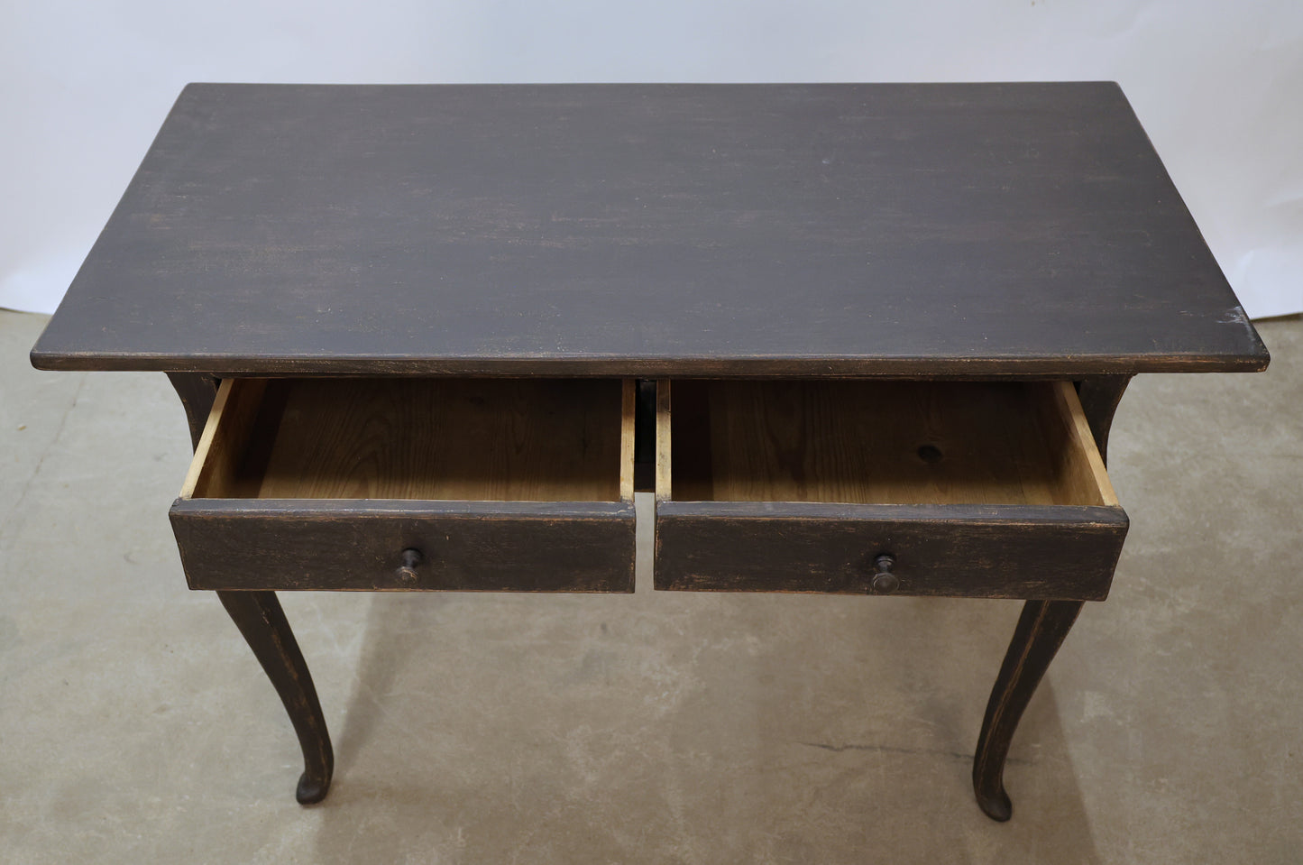 Antique desk from the Rococo epoch. The black desk is opened.