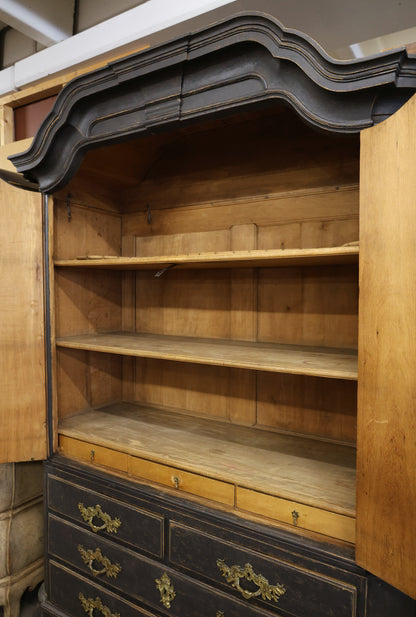 Opened doors of an antique cabinet.