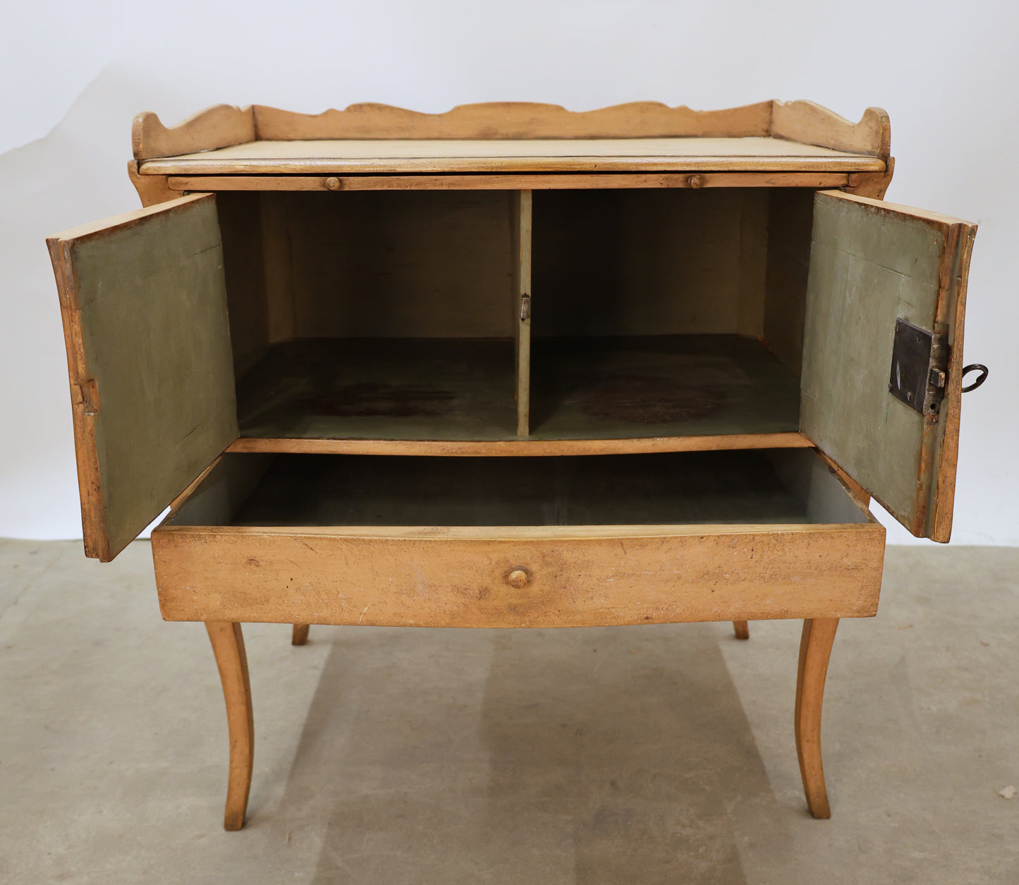 Antique Rococo nightstand in pink color, opened doors.