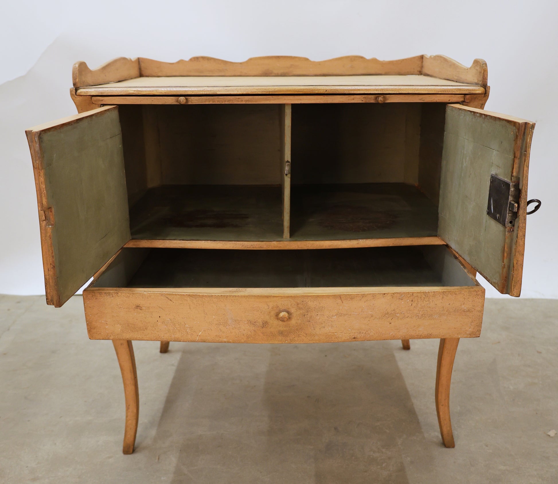 Antique Rococo nightstand in pink color, opened doors.