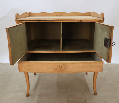 Antique Rococo nightstand in pink color, opened doors.